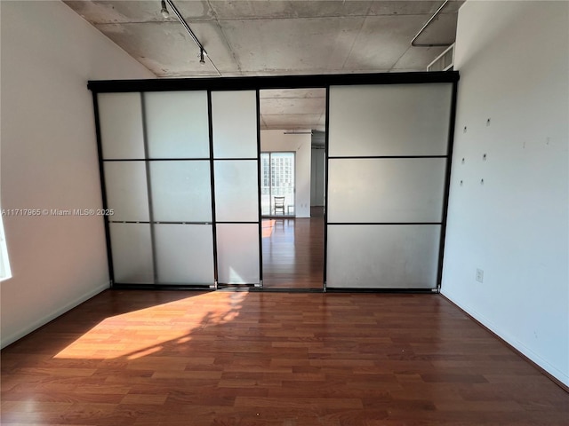 unfurnished bedroom featuring wood-type flooring and floor to ceiling windows