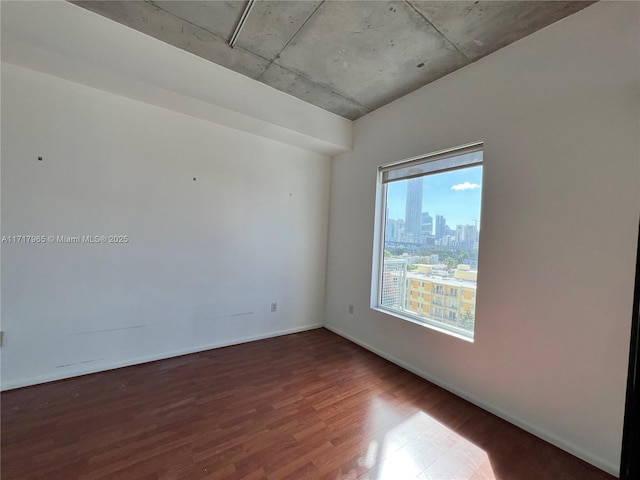 spare room with wood-type flooring