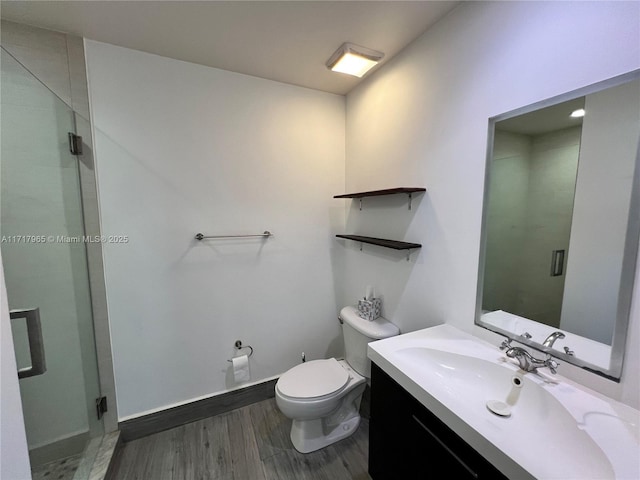 bathroom with wood-type flooring, toilet, and vanity