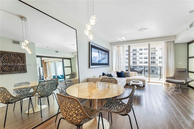 dining space featuring wood-type flooring