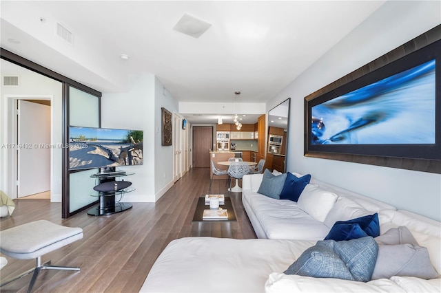 living room featuring a chandelier and hardwood / wood-style flooring