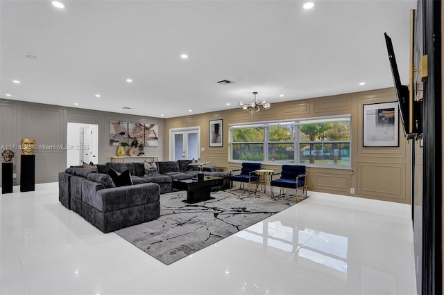 tiled living room with french doors and a notable chandelier