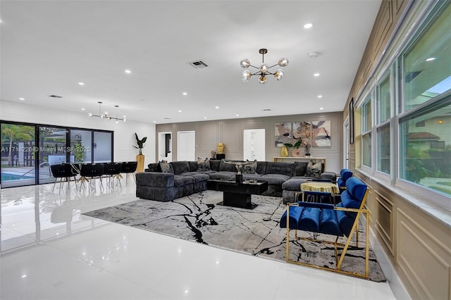 tiled living room featuring a notable chandelier