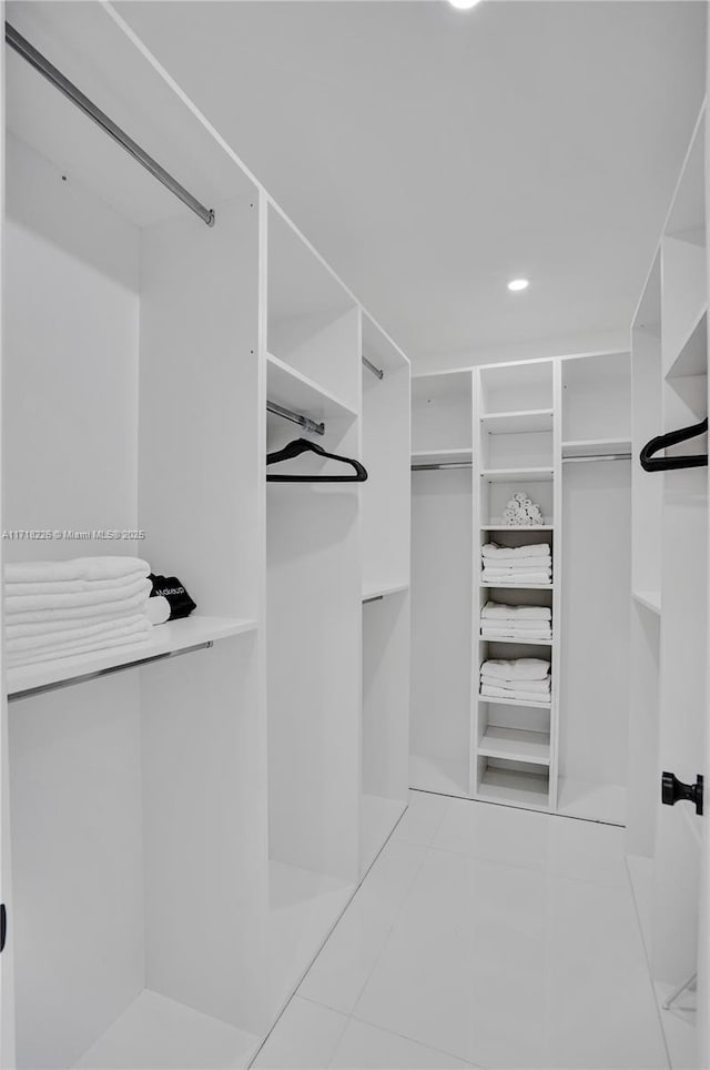 spacious closet featuring light tile patterned floors