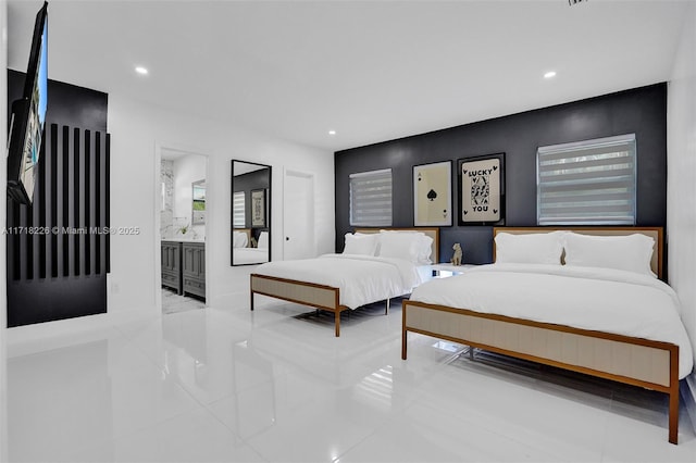 bedroom with light tile patterned flooring and ensuite bath