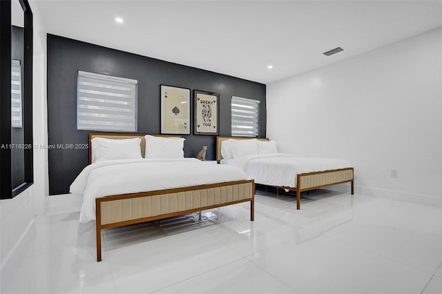 bedroom featuring tile patterned flooring and multiple windows