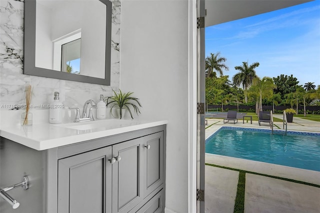 view of swimming pool with sink