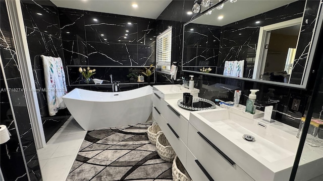 bathroom with a bathtub, vanity, and tile walls