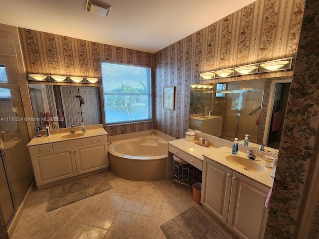 bathroom with plus walk in shower, tile patterned flooring, and vanity