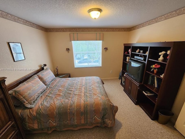 bedroom with carpet and a textured ceiling