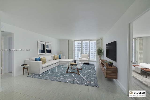 living room featuring light tile patterned floors and a wall of windows