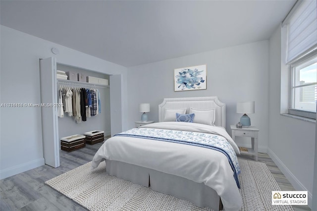 bedroom with light hardwood / wood-style flooring and a closet