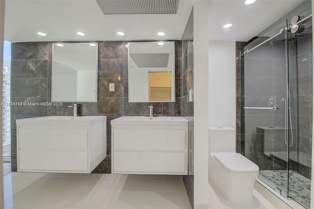 bathroom featuring vanity, tile patterned floors, toilet, tile walls, and walk in shower