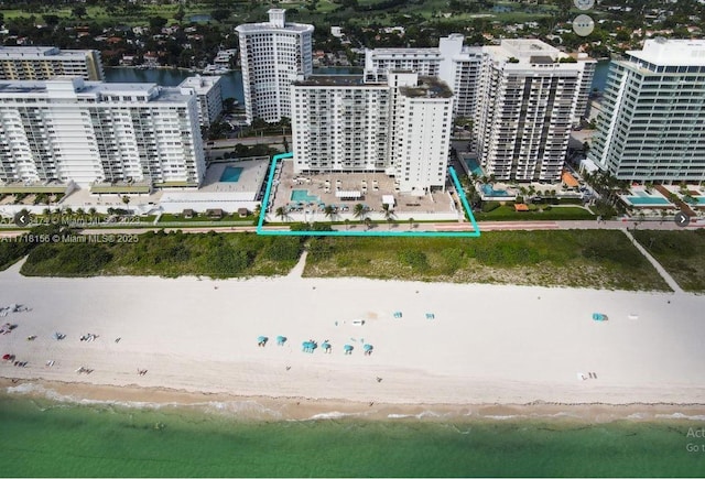 birds eye view of property featuring a view of the beach and a water view