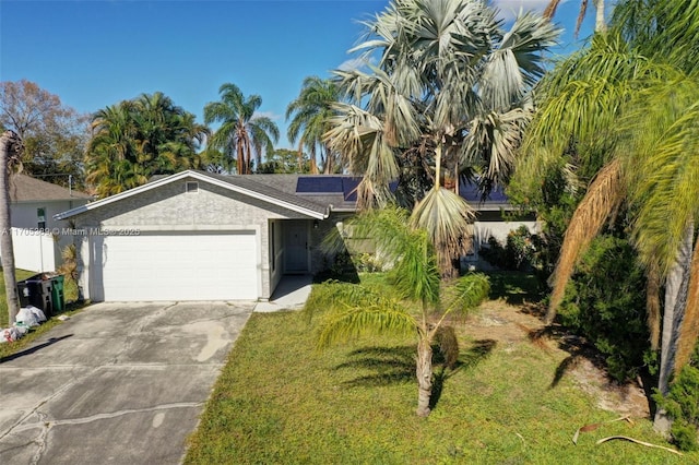 view of front of home featuring solar panels, a front lawn, and a garage