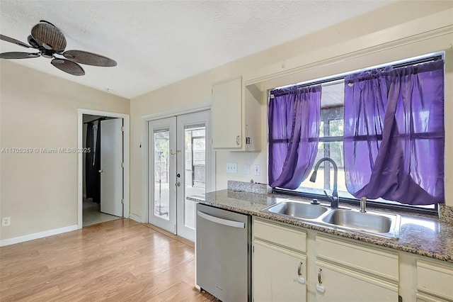 kitchen with sink, vaulted ceiling, dishwasher, french doors, and ceiling fan