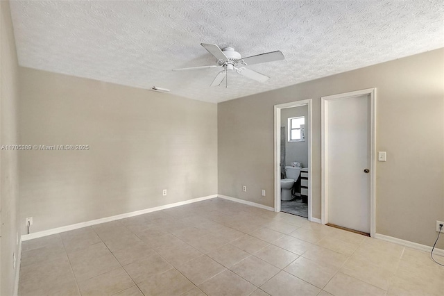 empty room featuring ceiling fan and light tile patterned floors