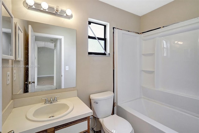 full bathroom featuring toilet, bathing tub / shower combination, and vanity