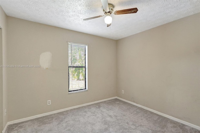 spare room with a textured ceiling, ceiling fan, and light carpet