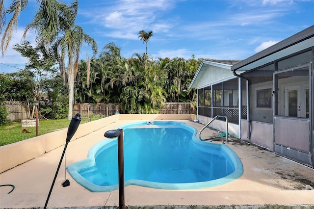 view of swimming pool with a patio and glass enclosure