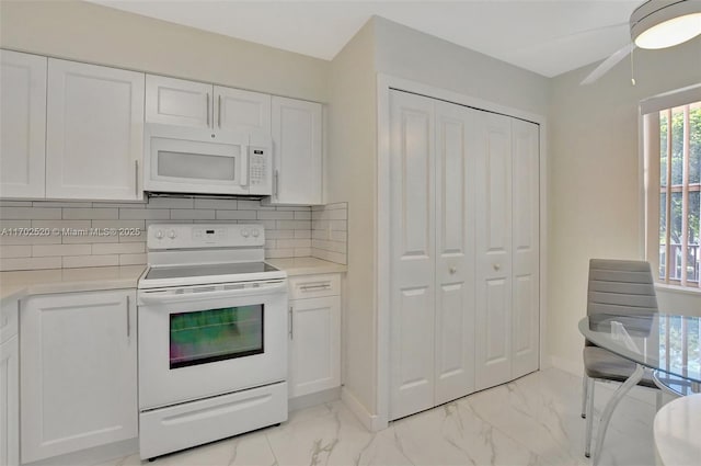 kitchen featuring white appliances, white cabinetry, ceiling fan, and backsplash