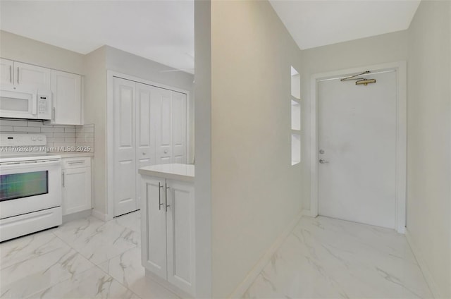 kitchen with white cabinetry, white appliances, and backsplash