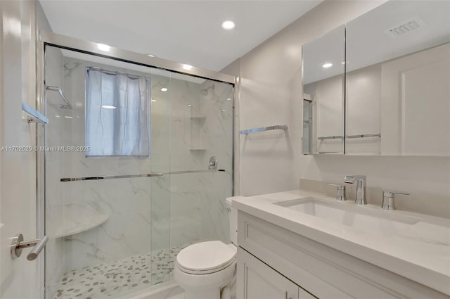 bathroom featuring vanity, toilet, and an enclosed shower