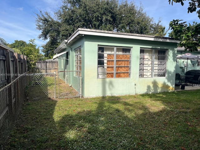 view of side of home featuring a yard