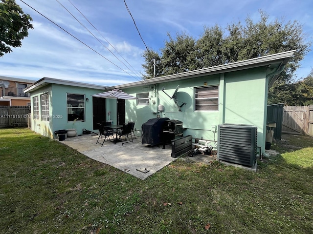 back of house with a lawn, a patio area, and central AC unit