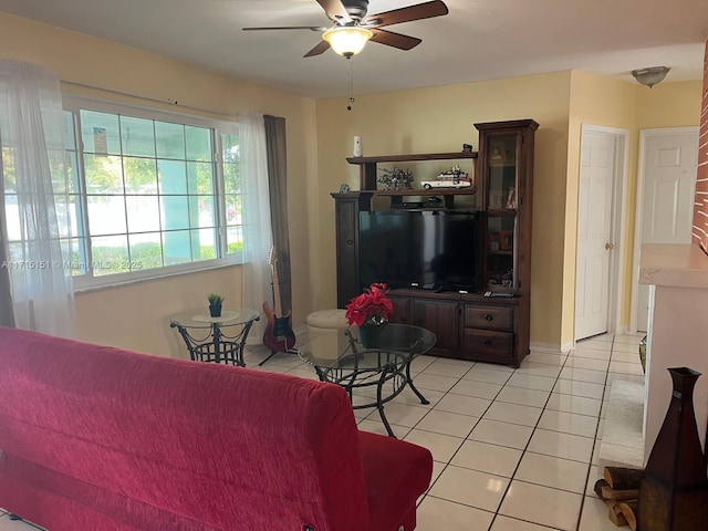 living room featuring ceiling fan and light tile patterned flooring