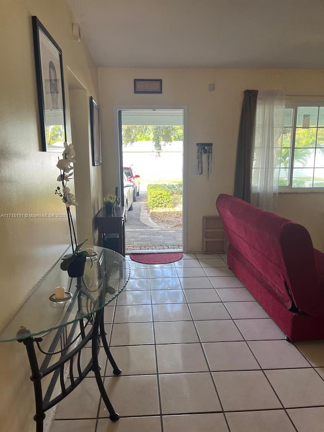 entryway with a wealth of natural light and light tile patterned floors