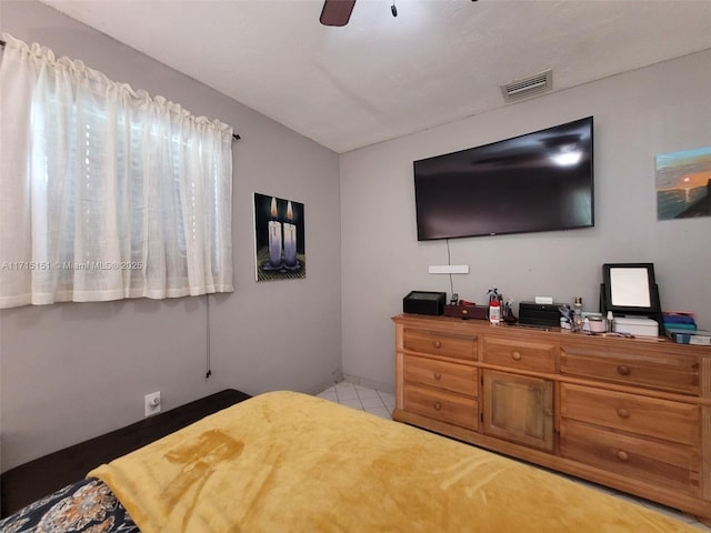 tiled bedroom with ceiling fan