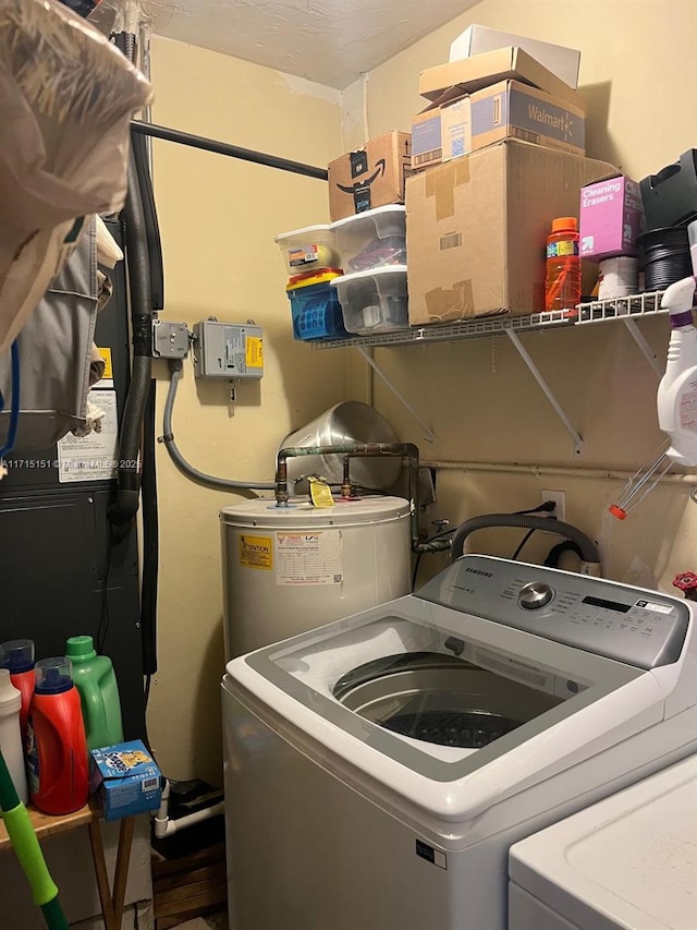 clothes washing area featuring separate washer and dryer and water heater