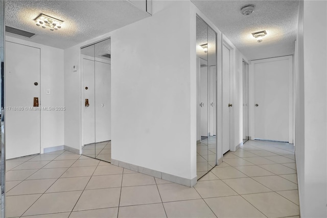 corridor featuring light tile patterned floors