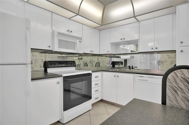 kitchen featuring white appliances, sink, light tile patterned floors, tasteful backsplash, and white cabinetry