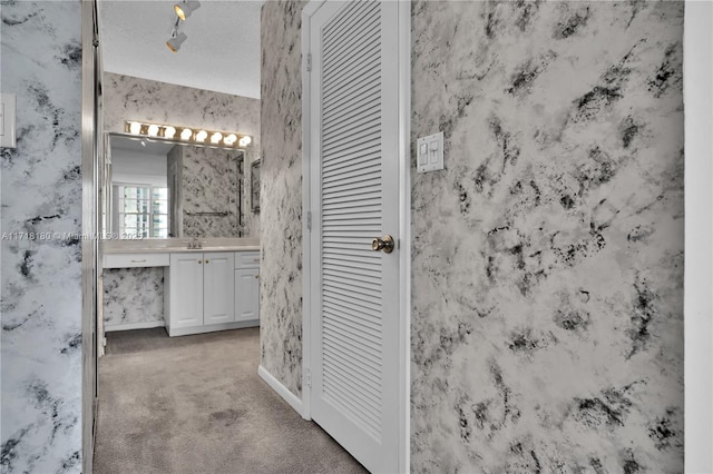 bathroom with a textured ceiling and vanity