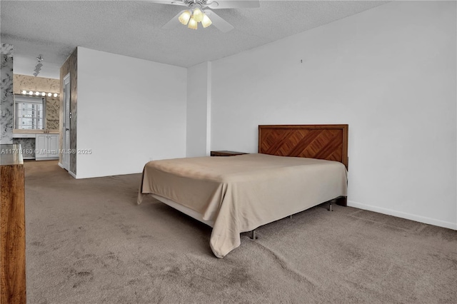 carpeted bedroom featuring a textured ceiling, ceiling fan, and connected bathroom