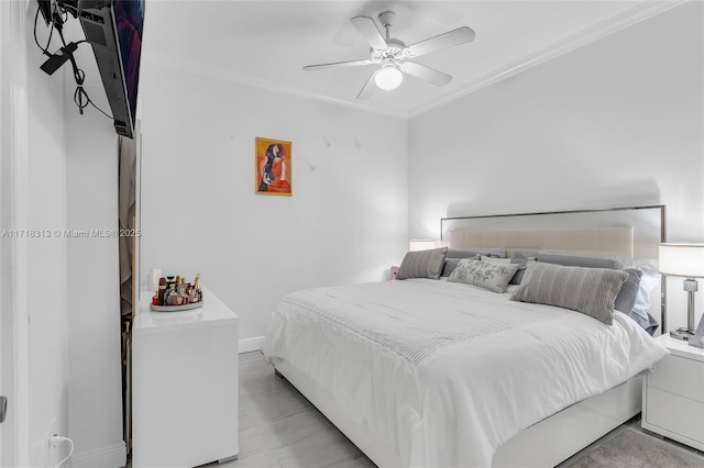 bedroom with ceiling fan and ornamental molding