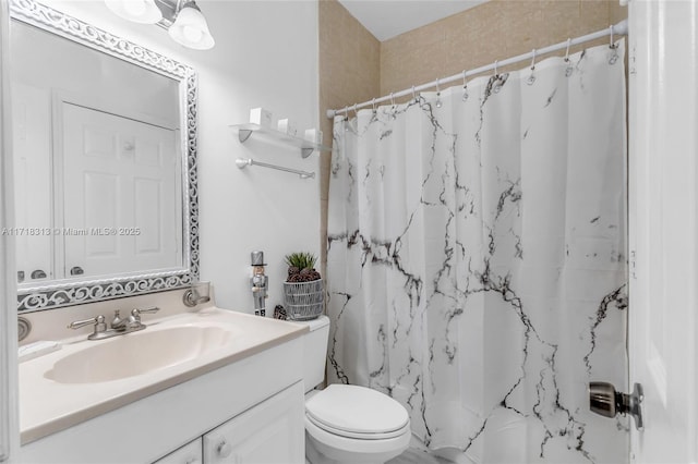 bathroom featuring vanity, toilet, and curtained shower