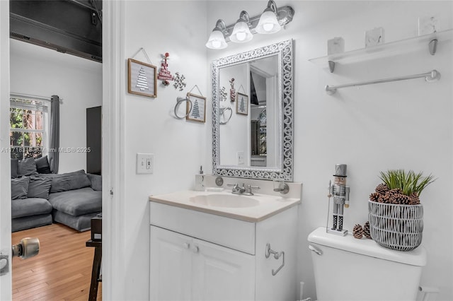 bathroom featuring hardwood / wood-style floors, vanity, and toilet