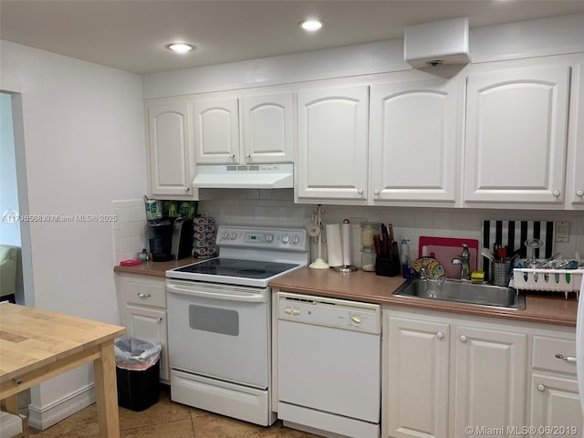 kitchen featuring light tile patterned floors, electric range oven, tasteful backsplash, white dishwasher, and white cabinets