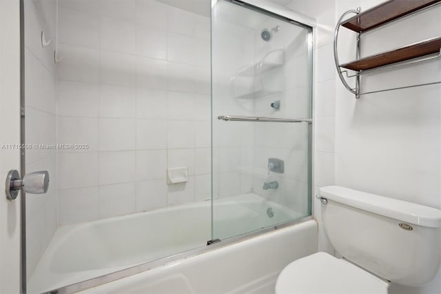 bathroom with toilet and bath / shower combo with glass door