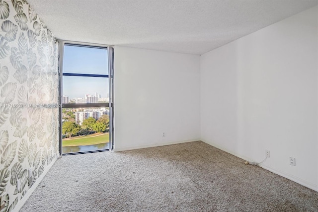20355 NE 34th Ct Unit 1828, Aventura, FL 33180 - empty room featuring carpet flooring, a textured ceiling, a water view, and a view of city