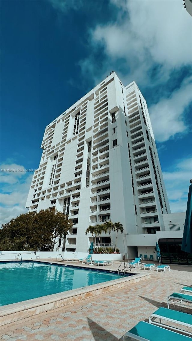 view of building exterior with a community pool