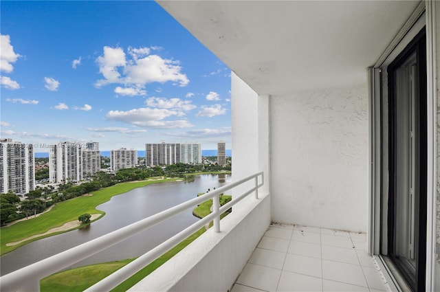 balcony featuring a city view and a water view