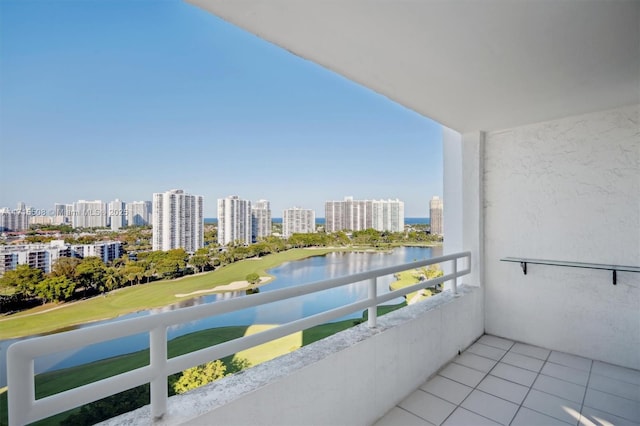 balcony with a water view and a view of city