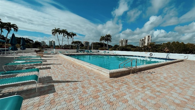 pool featuring a view of city and a patio