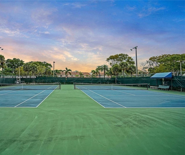 view of tennis court featuring fence