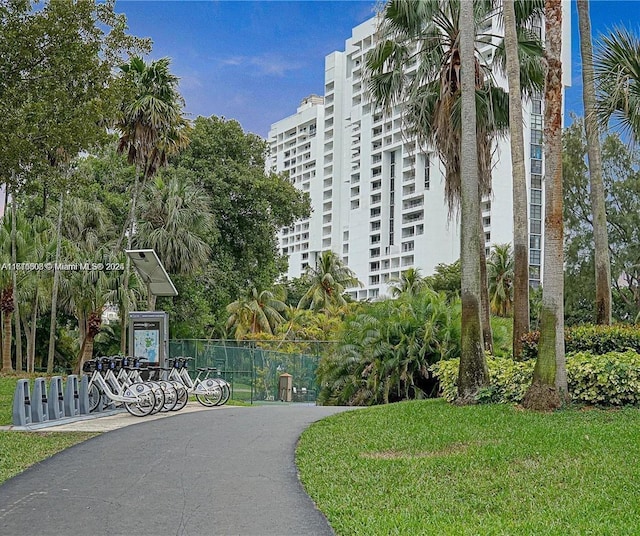 view of property's community featuring fence and a yard