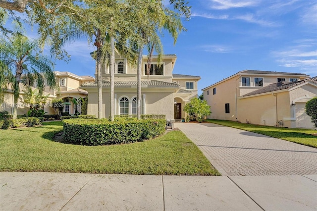 mediterranean / spanish-style house with a front lawn